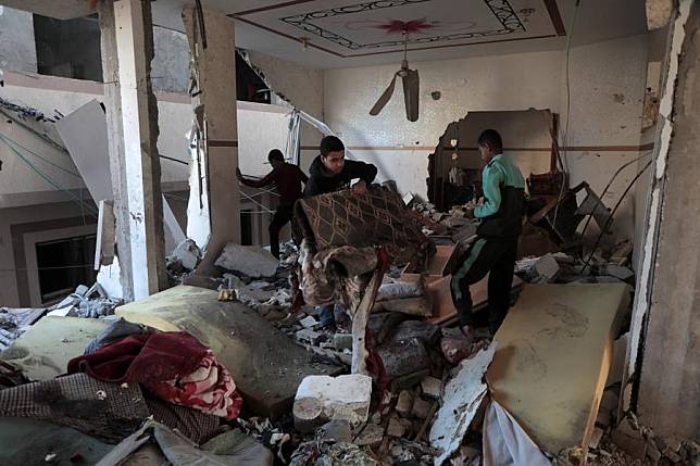 Palestinians are seen at the site of a destroyed house after an Israeli bombardment, in Deir al-Balah refugee camp in the central Gaza Strip, Jan. 9, 2025. (Photo by Rizek Abdeljawad/Xinhua)