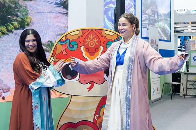 Visitors in traditional Hanfu attire pose for photos at the exhibition area of China during the 2025 FITUR international tourism exhibition in Madrid, Spain, Jan. 24, 2025. (Photo by Gustavo Valiente/Xinhua)