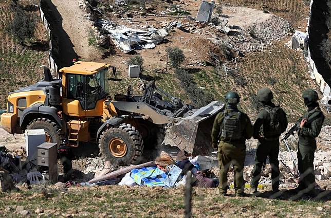 Israeli forces take security measures as Israeli army bulldozers demolish houses belonging to Palestinians in the Masafer Yatta district, south of the West Bank city of Hebron, on Feb. 18, 2025. (Photo by Mamoun Wazwaz/Xinhua)