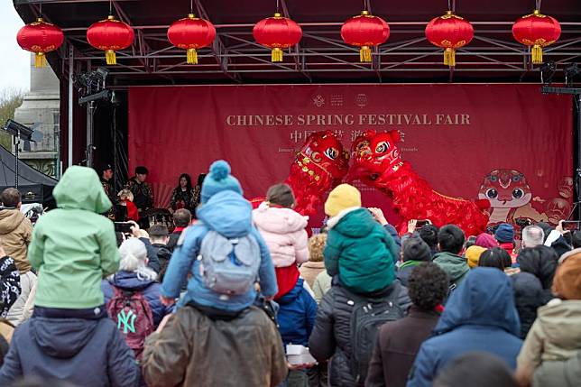 People watch a lion dance show at a temple fair in celebration of the upcoming Spring Festival, or the Chinese Lunar New Year, at the Cinquantenaire Park in Brussels, Belgium, Jan. 25, 2025. (Xinhua/Meng Dingbo)