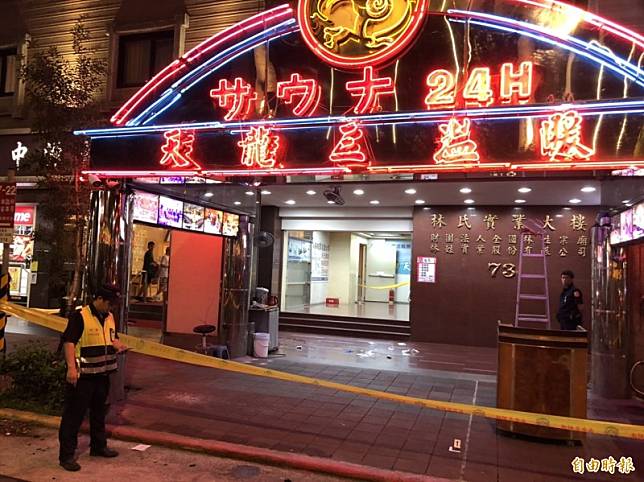 北市重慶北路一段一家三溫暖外有人受傷，救護人員趕到現場，將一名年約55歲的傷者送醫。(記者王冠仁攝)