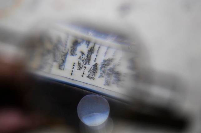 The profile photo shows a miniature artwork being seen under a magnifier at a studio in Chongqing, southwest China. (Xinhua/Wang Quanchao)