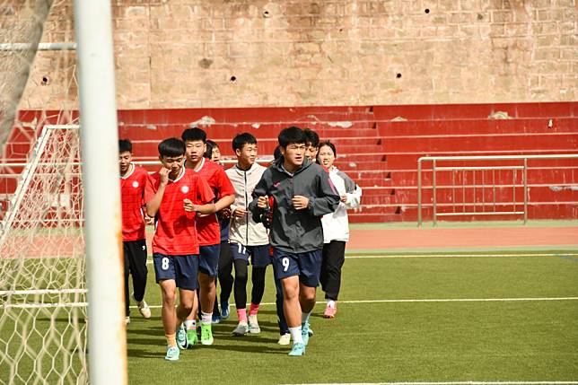 Students from Zhidan's youth football school conduct their training. (Xinhua/Yao Youming)