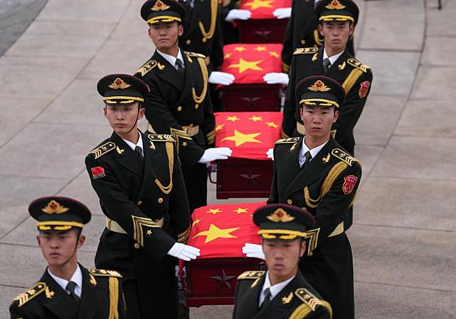 Guards of honor escort the caskets of the fallen Chinese People's Volunteers (CPV) martyrs during a burial ceremony at the CPV martyrs' cemetery in Shenyang, northeast China's Liaoning Province, Nov. 29, 2024. (Xinhua/Li Gang)