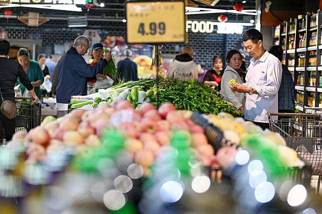 People shop at a supermarket in Nanjing, east China's Jiangsu Province, Oct. 13, 2024. (Photo by Fang Dongxu/Xinhua)