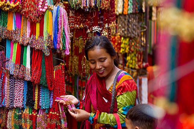 A woman is seen at a bead shop during the Hindu holy month of Shrawan in Kathmandu, Nepal, July 28, 2023. (Photo by Sulav Shrestha/Xinhua)