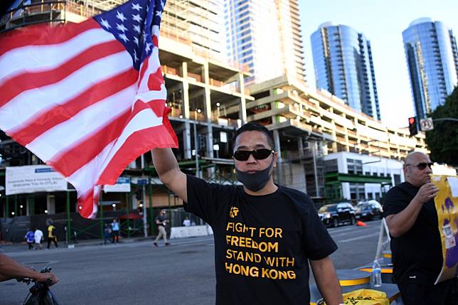 A fan wears a “Fight for Freedom, Stand with Hong Kong” T-shirt and holds a US flag before an NBA game at the Staples Center. Photo: USA Today Sports
