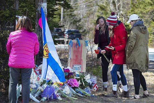 People pay their respects at a memorial in Portapique, Nova Scotia, following last Saturday’s shooting rampage. Photo: AP