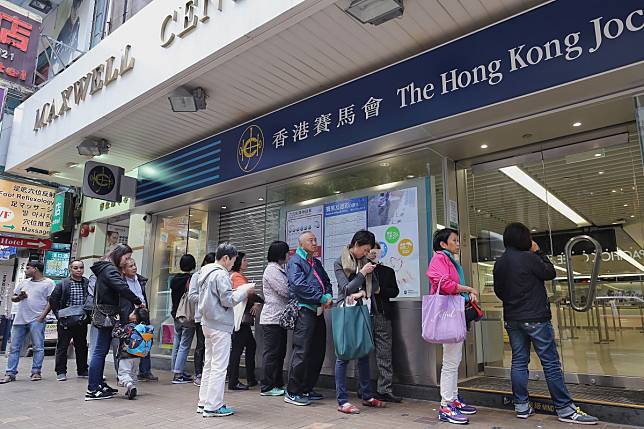 Punters line up to place bets at a Jockey Club betting branch. Photo: Winson Wong