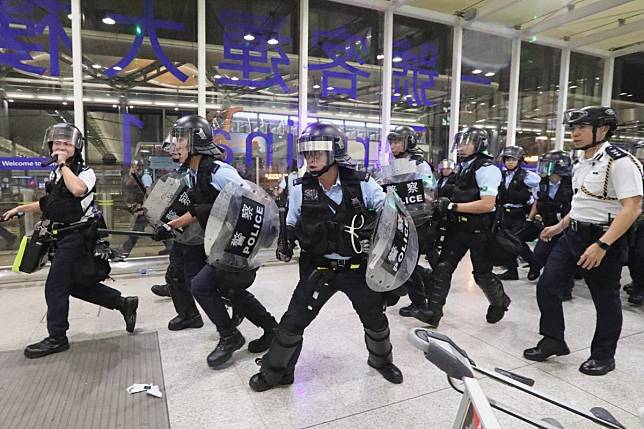 Riot police at the Hong Kong International Airport on Tuesday, August 13. Photo: Felix Wong