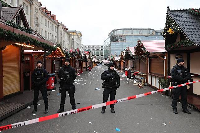 Policemen stand guard at a Christmas market where a car rammed into a crowd in Magdeburg, Germany, Dec. 21, 2024. At least five people were killed and over 200 others injured after a car rammed into a large crowd at a German Christmas market in the central German city of Magdeburg Friday evening, German news agency dpa reported Saturday, citing State Premier Reiner Haseloff. (Xinhua/Du Zheyu)