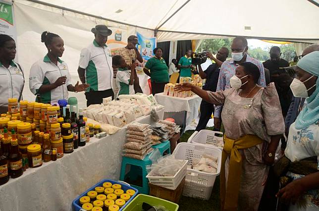 Photo taken on Oct. 16, 2022 shows Ugandan Prime Minister Robinah Nabbanja (2nd R, front) visiting a stall during an agricultural products' exhibition to mark the World Food Day at National Crops Resources Research Institute, Wakiso district, Uganda. (Photo by Nicholas Kajoba/Xinhua)