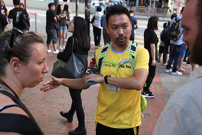 Protest Tour guide Michael Tsang Chi-fai (centre) takes tourists Sarah Severance (L) from US and Andrew Jones ® from UK, around the protest areas, Tin Hau. 02NOV19 SCMP / Xiaomei Chen