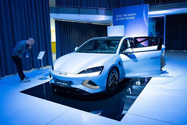 A man looks at a BYD electric vehicle in Budapest, Hungary, Oct. 17, 2023. (Photo by Attila Volgyi/Xinhua)