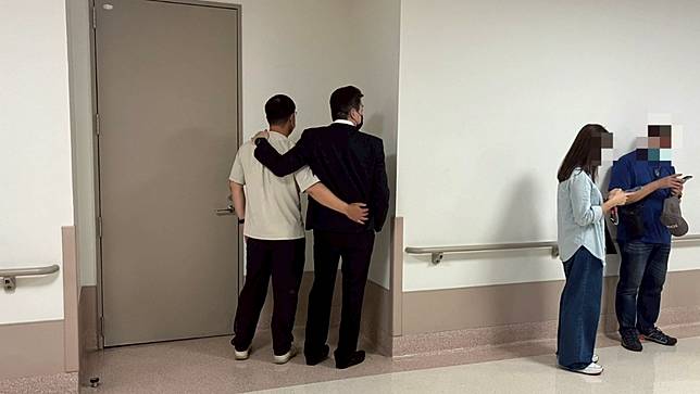 圖中灰色衣服是張姓女學生的父親，探視完女兒，友人攙扶之下在角落低聲啜泣。游騰傑攝