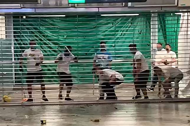 A mob in white T-shirts attacked passengers, black-clad extradition bill protesters and journalists on Sunday at Tuen Long MTR station. Photo: Jeffie Lam