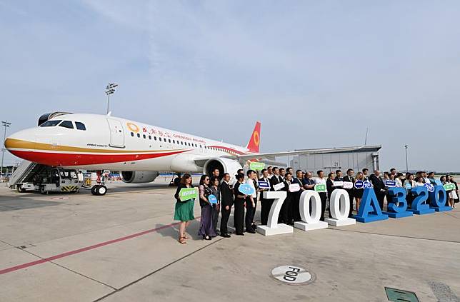 Guests attending the delivery ceremony of the 700th A320 family aircraft assembled by Airbus Tianjin to Chengdu Airlines pose for a group photo in front of the A320neo aircraft in Tianjin, north China, July 8, 2024. (Xinhua/Li Ran)