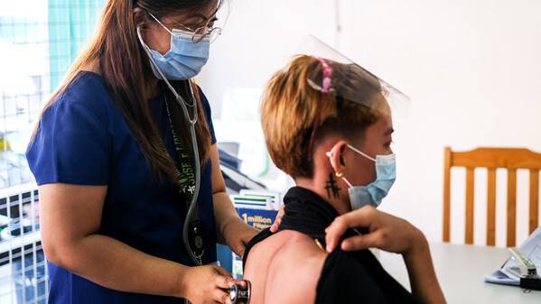 TB researcher and clinician examines a DR-TB survivor who was treated with the BPaL regimen. Credit: Veejay Villafranca/TB Alliance