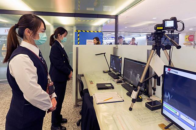 Staff from Taiwan's Centre for Disease Control use thermal scanners to screen passengers arriving on a flight from Wuhan. Photo: AFP