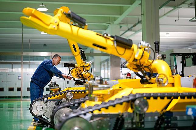 A worker adjusts a robot product at the workshop of CITIC HIC Kaicheng Intelligence Equipment Co., Ltd. in Tangshan National High-tech Industrial Development Zone in Tangshan, north China's Hebei Province, Feb. 18, 2025. (Xinhua/Mu Yu)