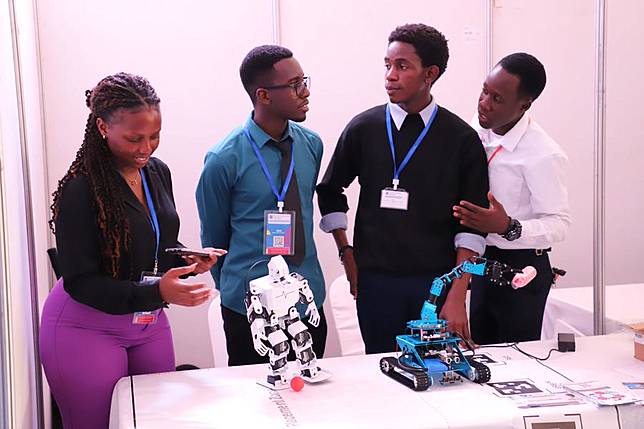 Students showcase their robotic designs during a job fair in Kampala, Uganda, on Nov. 21, 2024. (Photo by Ronald Ssekandi/Xinhua)