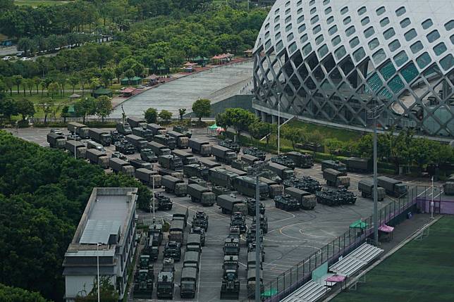 Armoured vehicles and trucks stationed in Shenzhen, near the border with Hong Kong. Photo:AP Photo/Dake Kang