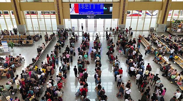 An aerial drone photo taken on April 12, 2024 shows passengers at the Vientiane Station of the China-Laos Railway in Vientiane, Laos. (Photo by Yang Yongquan/Xinhua)