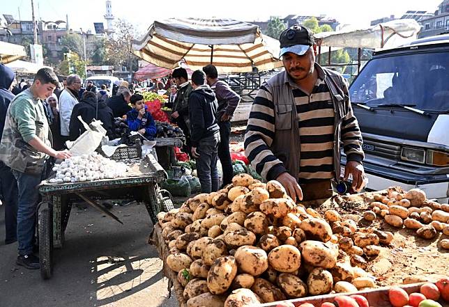 Vendors display their goods for sale along a street in Damascus, Syria, Dec. 16, 2024. (Photo by Ammar Safarjalani/Xinhua)