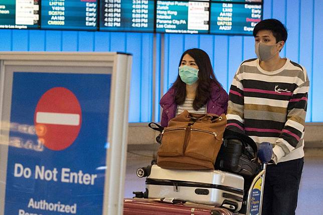 Travelers arriving at the Los Angeles International Airport on Wednesday wore protective masks. A Centres for Disease Control and Prevention official said on Monday that while 110 persons were under observation for the coronavirus, “at this time in the US, this virus is not spreading”. Photo: AFP