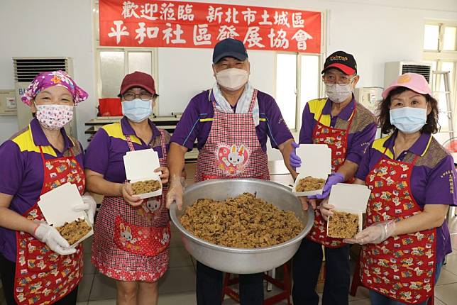 土城平和社區小產業油飯遠近馳名 剛攪拌好的油飯貢貢香 中為創會長林錦松。（新北市社會局提供）