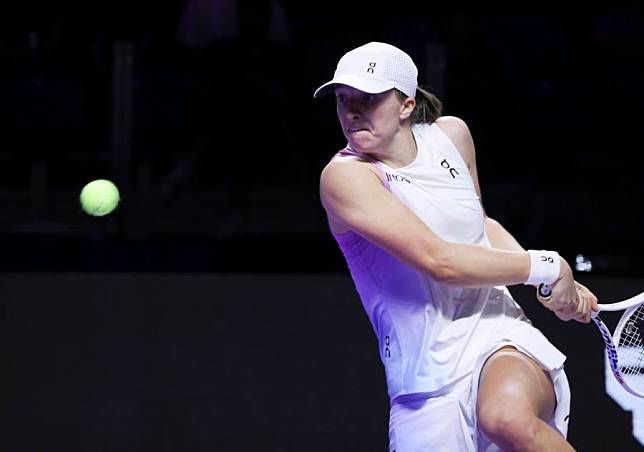 Iga Swiatek of Poland hits a return during the round robin match against Coco Gauff of the United States at WTA Finals tennis tournament in Riyadh, Saudi Arabia, Nov. 5, 2024. (Xinhua/Luo Chen)