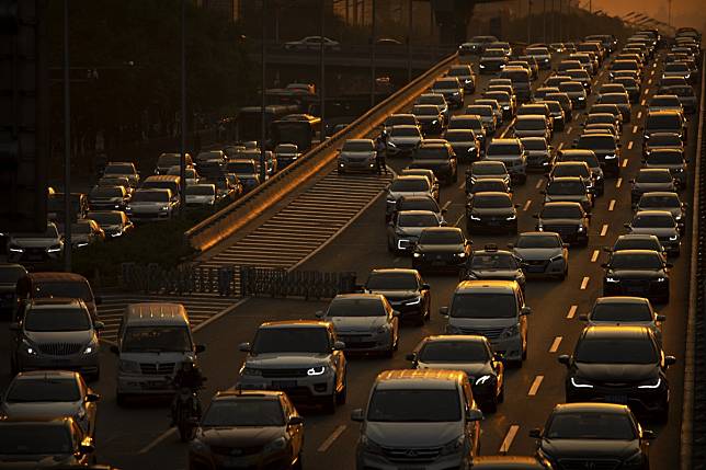 Commuters make their way along an expressway during rush hour in Beijing. Photo: AP