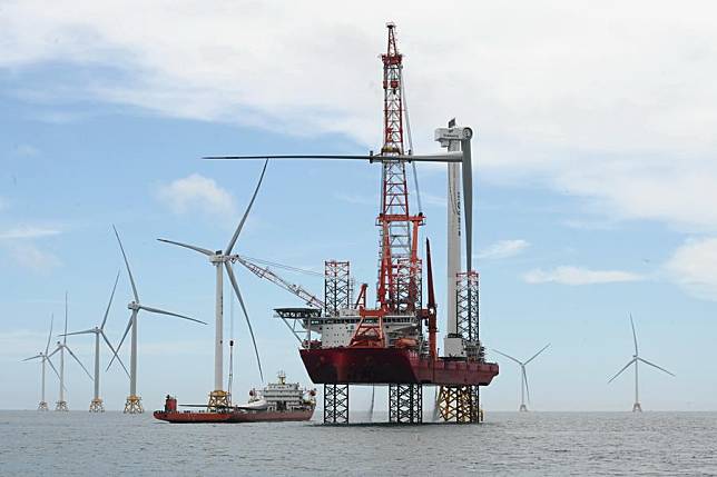 This photo taken on June 19, 2024 shows workers installing the blade of a 16-megawatt wind turbine of the phase II project of Zhangpu wind farm in southeast China's Fujian Province. (Xinhua/Lin Shanchuan)