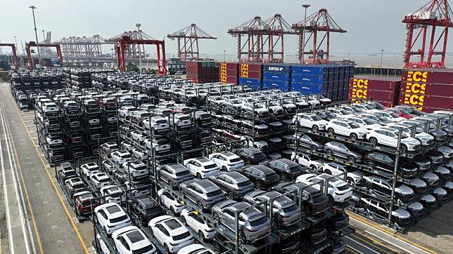 An aerial panoramic drone photo taken on July 11, 2023 shows new energy vehicles for export at a terminal of Taicang Port, east China's Jiangsu Province. (Photo by Ji Haixin/Xinhua)