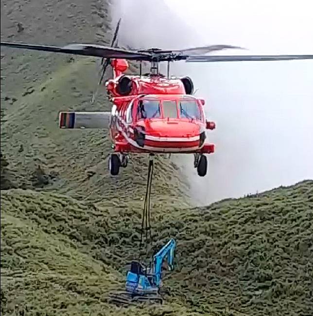 空勤黑鷹直升機不僅執行山難救援任務，也會支援空中運補勤務，就連挖土機也吊掛上山，讓民眾大開眼界。（記者陳金龍翻攝）
