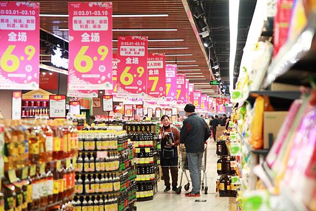 A customer shops at a supermarket in Nanjing, east China's Jiangsu Province, March 9, 2024. (Photo by Liu Jianhua/Xinhua)