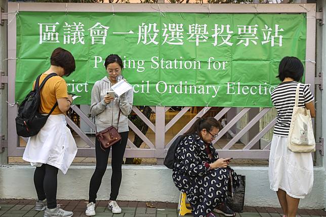 People queue up for the district council elections at Sha Tin Government Secondary School. Photo: Winson Wong