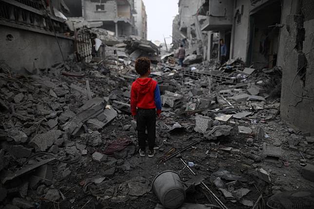 A boy stands in front of the rubble after an Israeli airstrike in Maghazi refugee camp, central Gaza Strip, on April 4, 2024. (Xinhua)