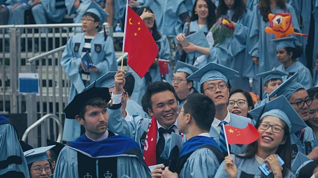 Graduates wave Chinese national flags during a commencement ceremony at Columbia University in New York.