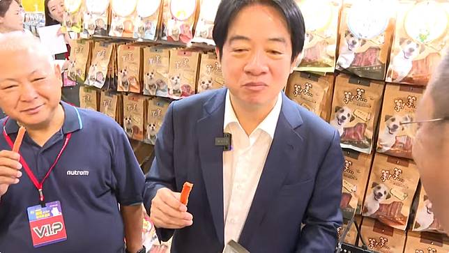 總統賴清德今上午出席台北寵物用品展，在逛到某處狗肉乾攤位時，直接將狗肉乾拿起來試吃，讓一旁的隨扈、幕僚都十分驚訝。(翻攝共訊)