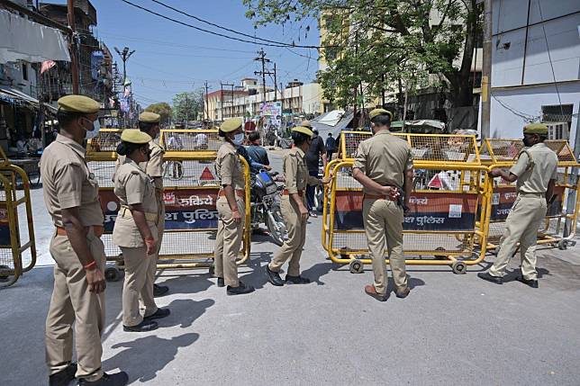 Police officers in India block off a road to Prayagraj’s old town after a resident tests positive for the coronavirus. Photo: Prabhat Kumar Verma