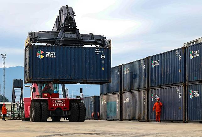 A forklift loads cargo containers at the Ningde land port in Ningde, southeast China's Fujian Province, Feb. 8, 2024. (Xinhua/Zhou Yi)