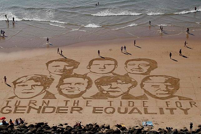 A drawing in the sand of the G7 leaders on a beach in Biarritz urges them to support gender equality. Photo: AFP