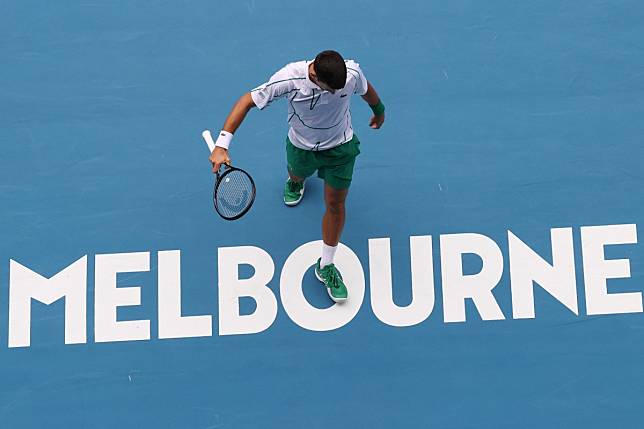 Novak Djokovic walks back to hit a return against Tatsuma Ito in the second round of the Australian Open. Photo: AFP