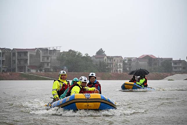 Rescue workers take boats towards Chengjiadun Village in Wukou Town, Leping City, east China's Jiangxi Province, June 26, 2024. (Xinhua/Sui Shangjun)