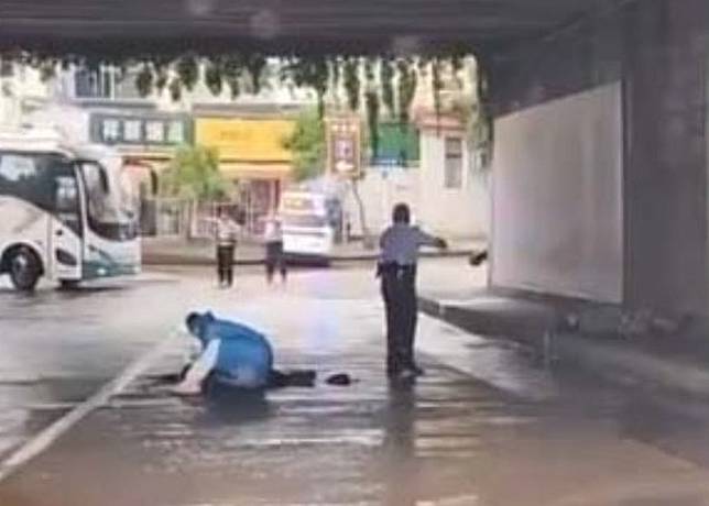 有警員中槍倒地，另一名警員在旁邊戒備。