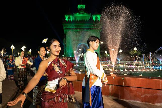 People participate in a New Year celebration at the Patuxay Park in Vientiane, Laos, Dec. 31, 2024. (Photo by Kaikeo Saiyasane/Xinhua)