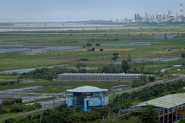 高屏溪流域範圍廣泛，圖下方藍色建築為昭明取水口，遠方為高屏溪口西岸的林園工業區，圖中間有一座水管橋（鵝黃色管線）連接高屏地區，作為跨河輸水用途。（攝影／謝佩穎）