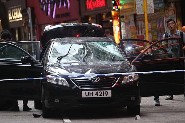 Police cordon off the car that the attackers left behind in Wan Chai on Sunday. Photo: David Wong