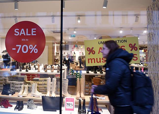 A woman walks past a store in Vienna, Austria, on March 1, 2024. (Xinhua/He Canling)